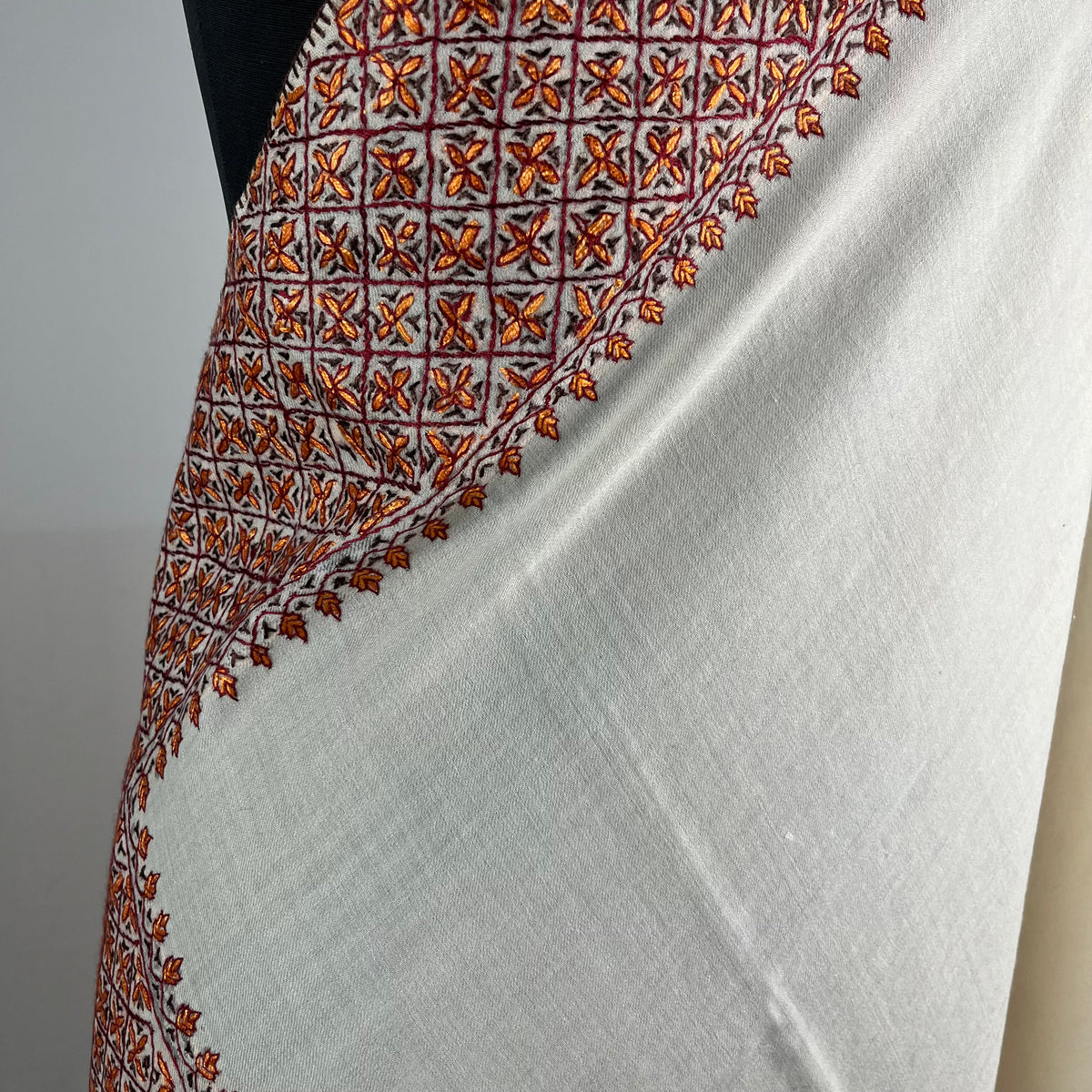 Detail of hand-stitched Sozni work on white Kashmiri Pashmina shawl