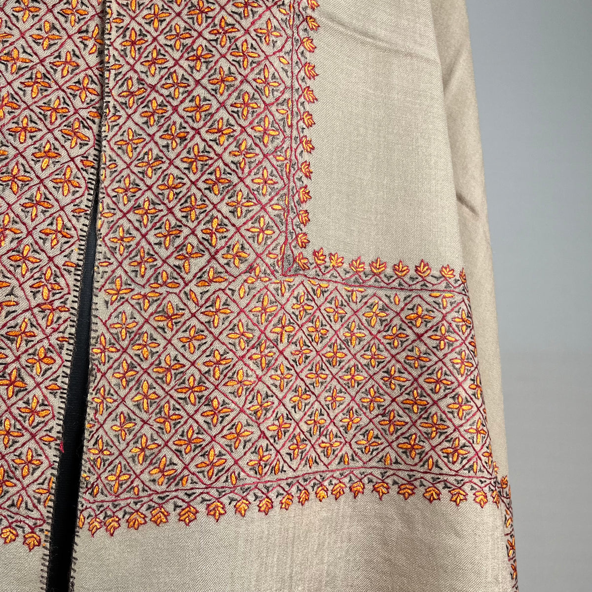 Detail of hand-stitched Sozni embroidery on light brown Pashmina shawl