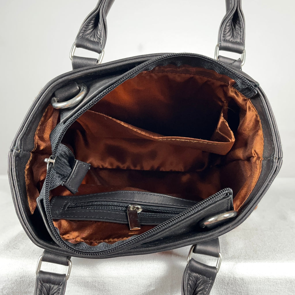 Black leather tote bag shown with detachable sling strap